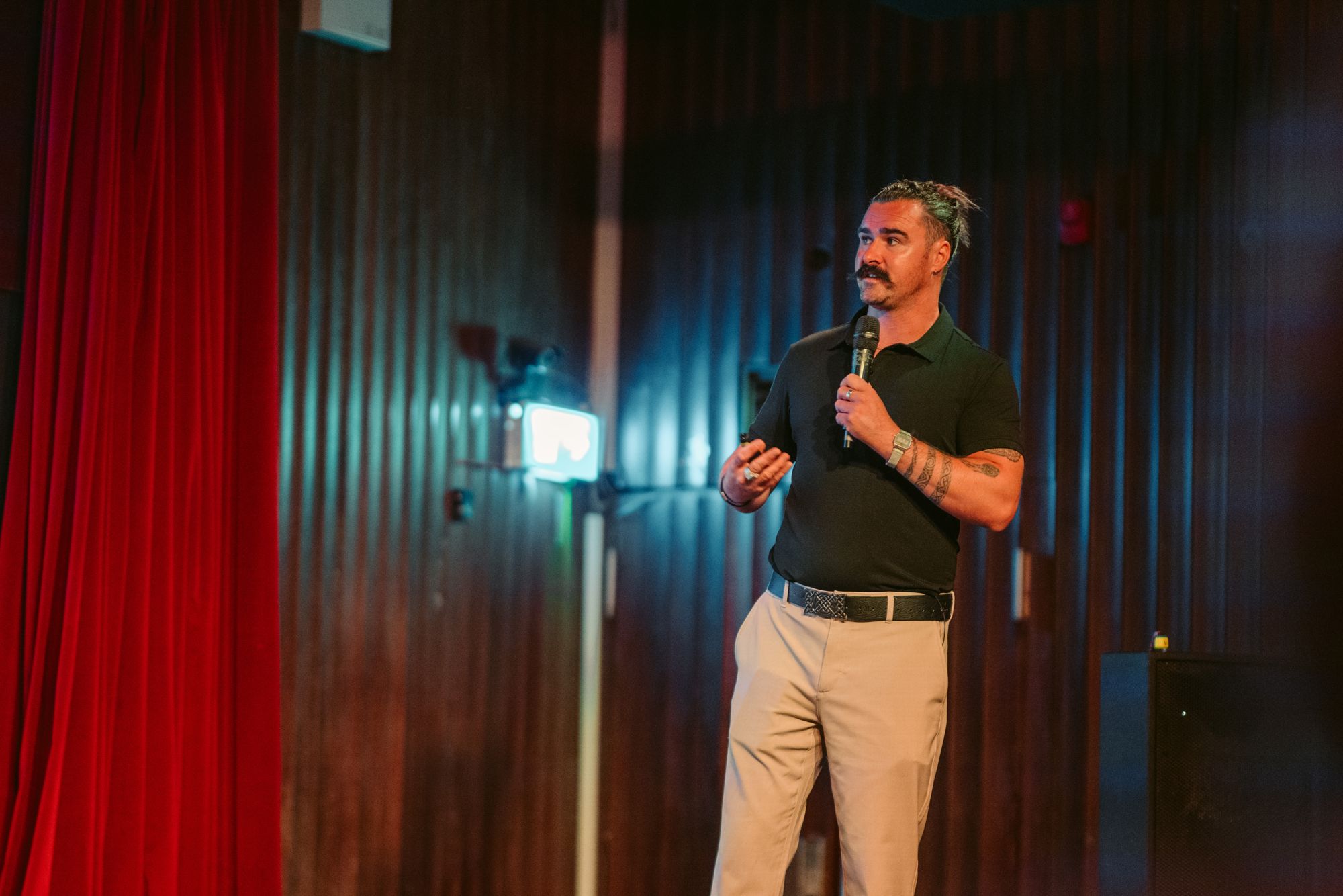 Dr. Darragh Stewart speaking on stage with a microphone